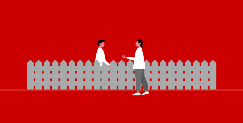 two people talking over a fence